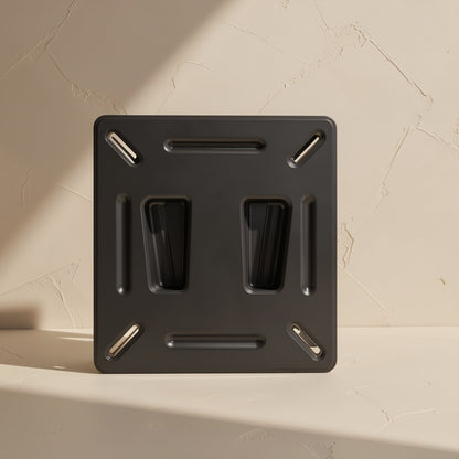 Wallpivot – Black keyhole-style mount standing upright against a textured cream wall, showing the front plate