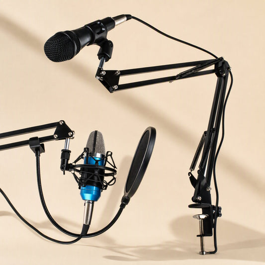 Slantreach – Black boom arm stand holding a handheld microphone, with a blue condenser mic and pop filter beside it