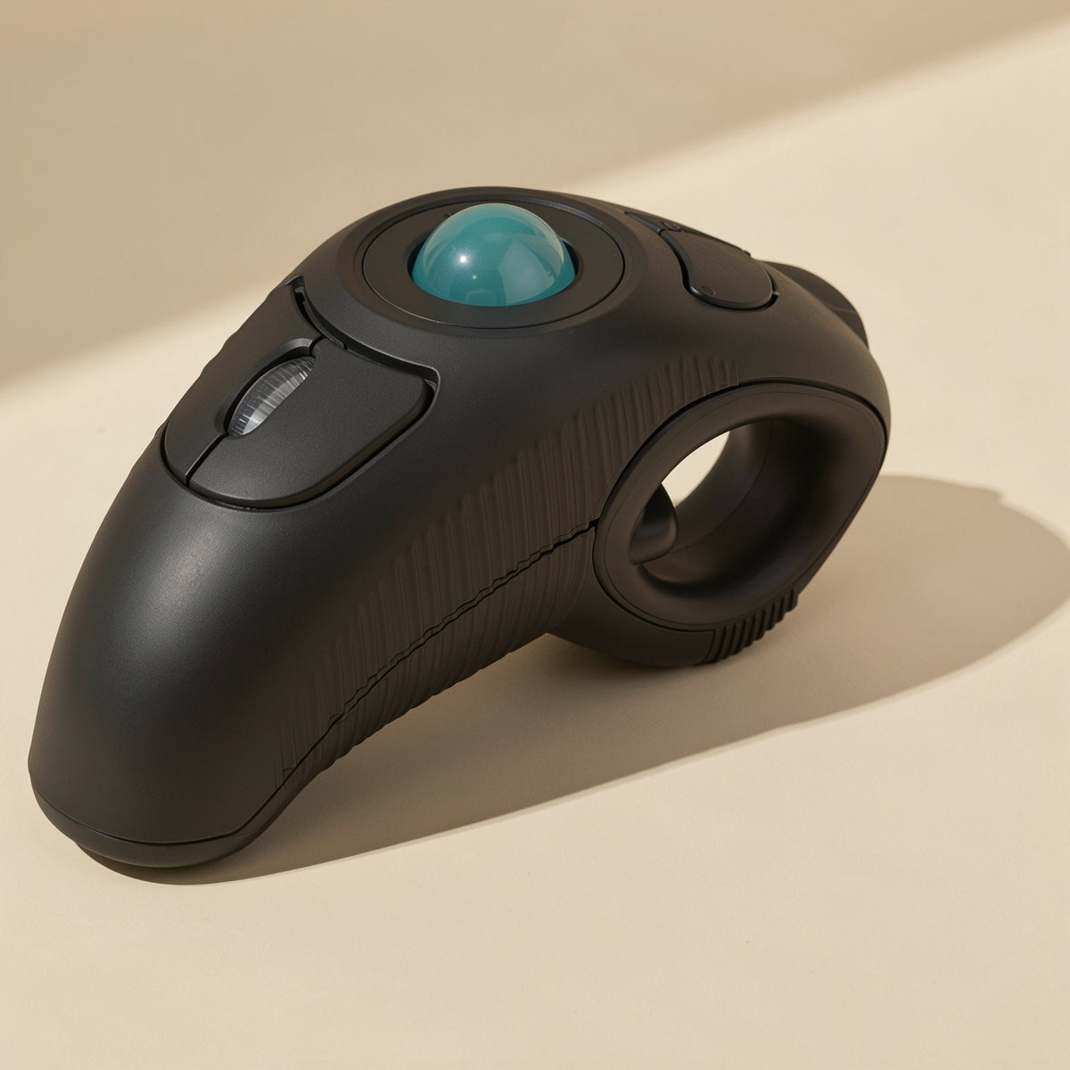Ballroam 2.4GHz Wireless Trackball Mouse in black with teal ball, three-quarter view on a cream surface