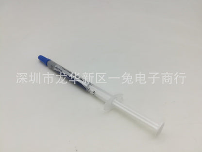 Thermend – Thermal paste syringe viewed from plunger end, clear barrel and white plunger flange, blue cap at top left