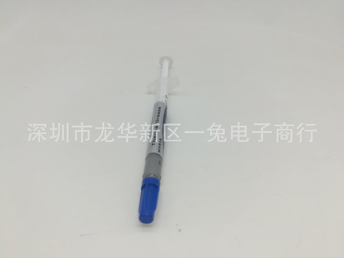 Thermend – Thermal grease syringe at a slight angle, blue cap at bottom, gray labeled barrel and clear plunger above