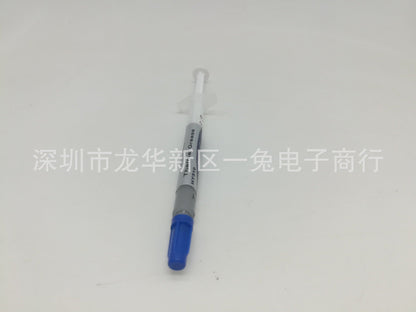 Thermend – Thermal grease syringe at a slight angle, blue cap at bottom, gray labeled barrel and clear plunger above