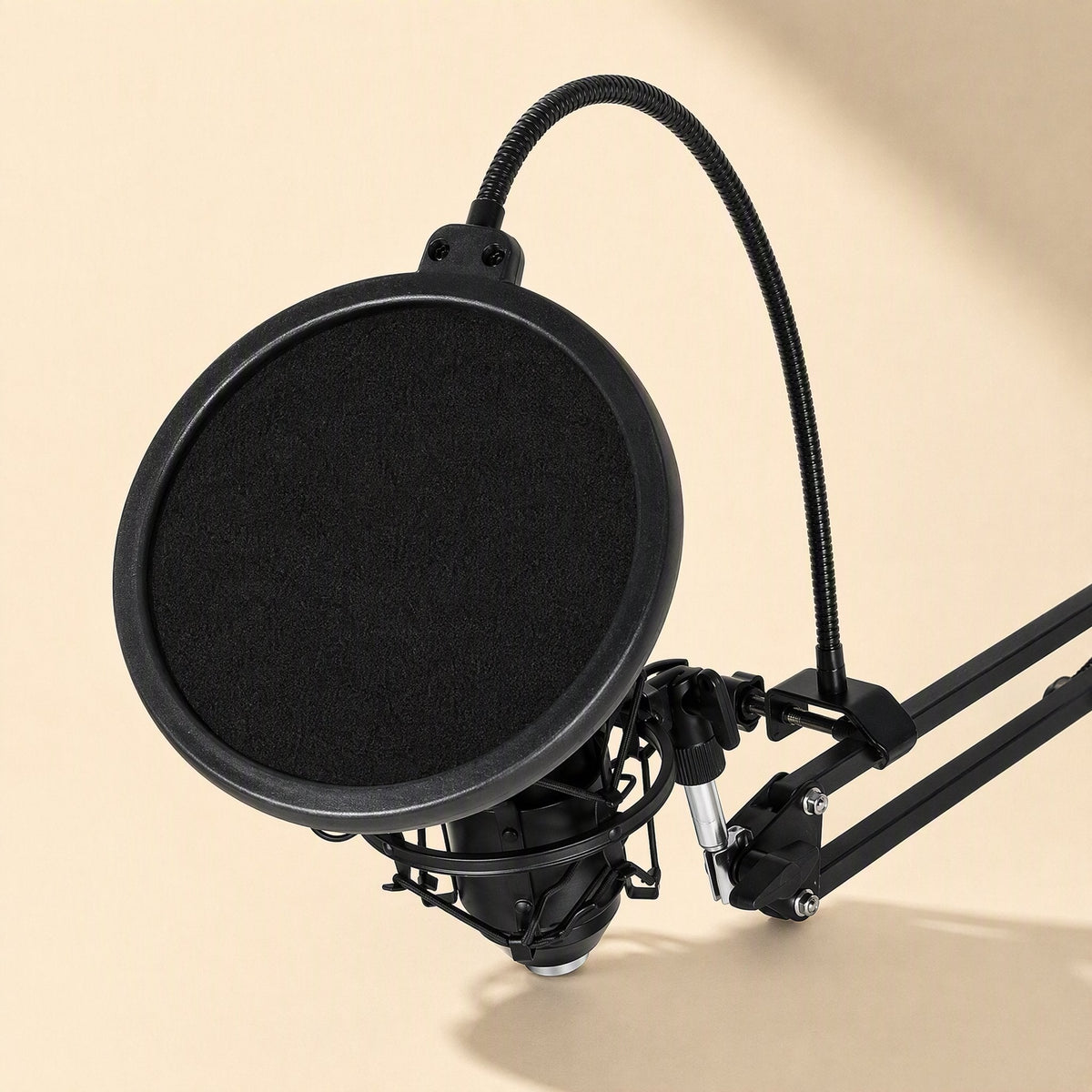 Popmesh Black Microphone Pop-Up Net Cover mounted on a boom arm in front of a black condenser microphone