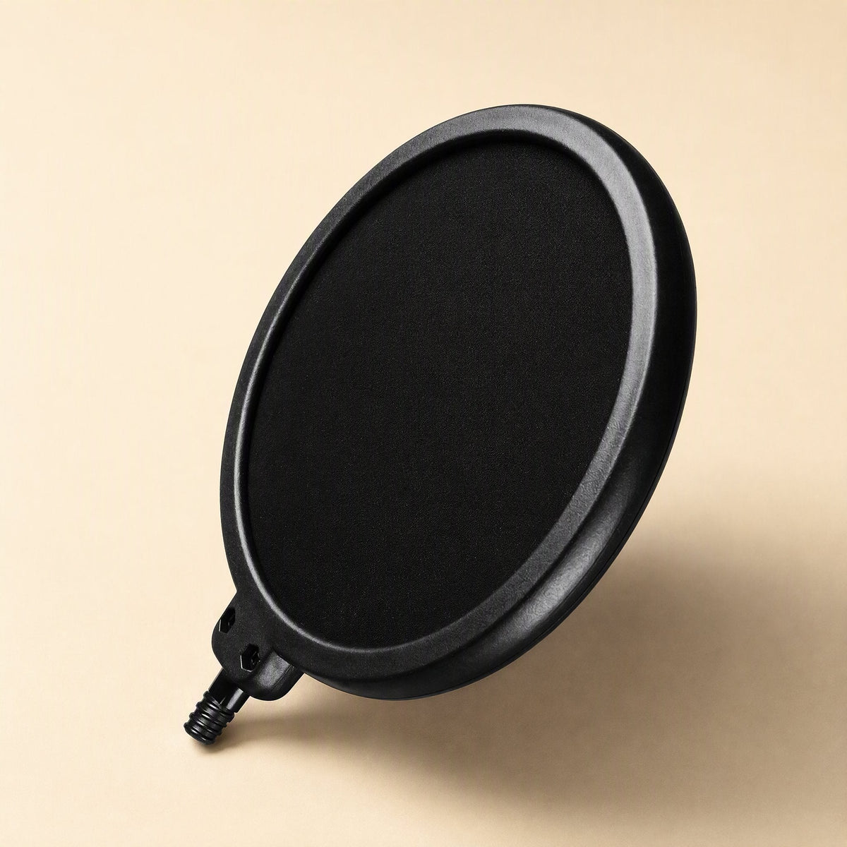 Popmesh – Black round pop filter screen with a short threaded connector at the base, angled on a beige background