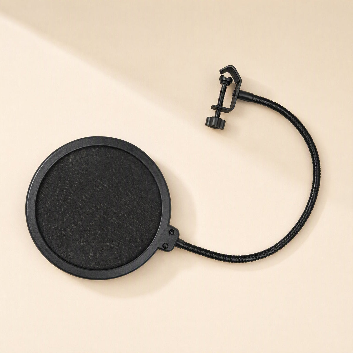 Popmesh – Black pop filter with a curved gooseneck arm and screw clamp, laid flat on a cream surface