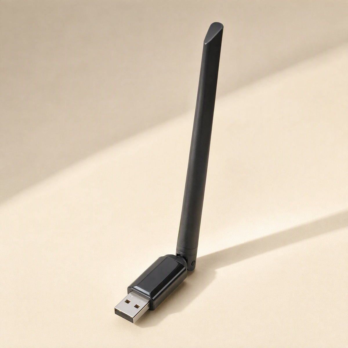 Wavebeam – Slim black USB wireless adapter with one tall antenna and a standard USB plug, seen from above