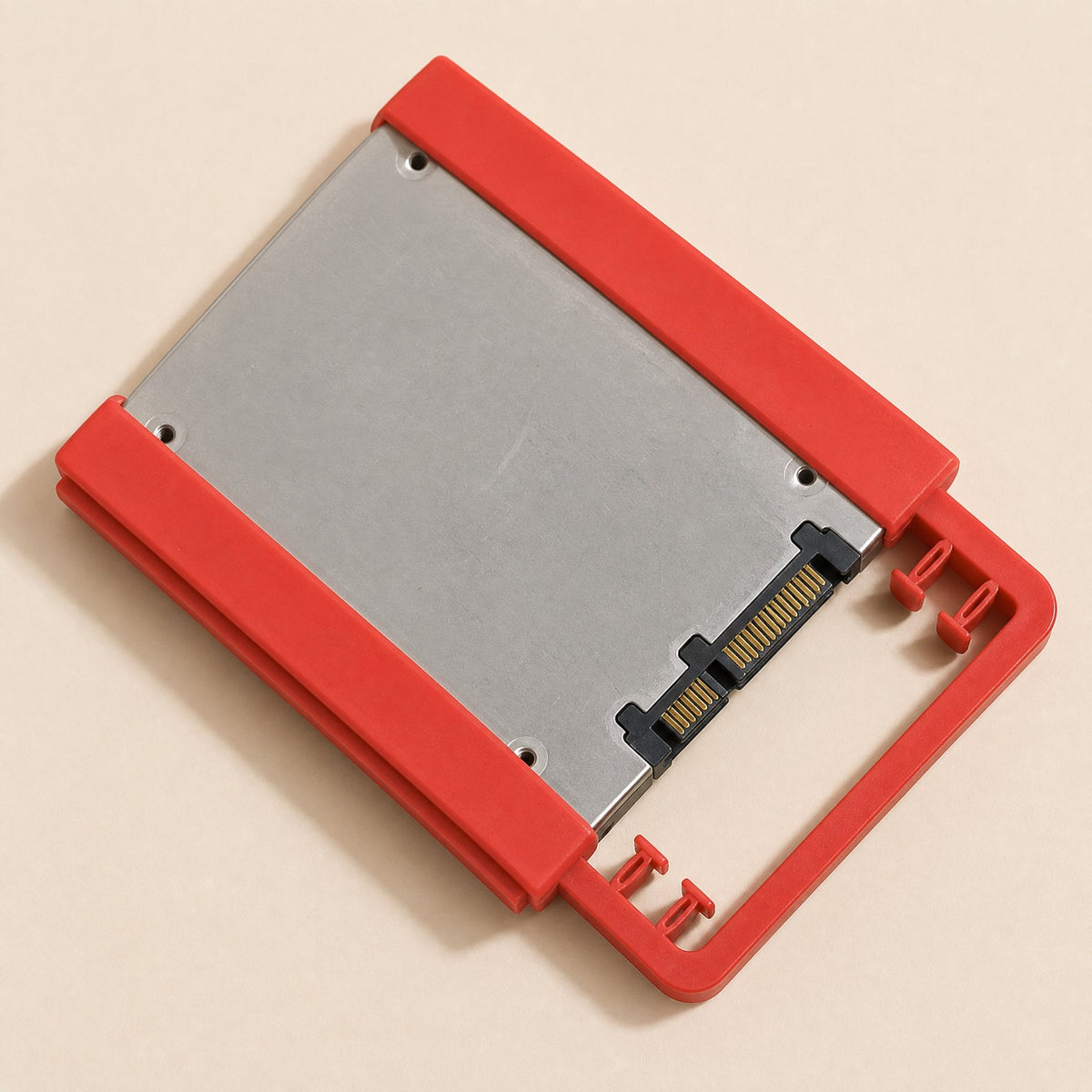 Driveclip – Red bracket holding a 2.5 inch SSD, shown from above with the SATA connector at the lower right