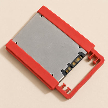 Driveclip – Red bracket holding a 2.5 inch SSD, shown from above with the SATA connector at the lower right