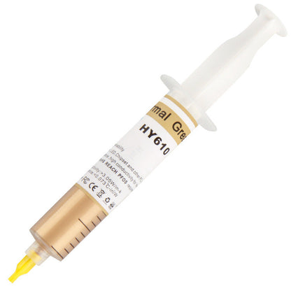 Goldglide Thermal Paste syringe angled upward, white HY610 label wrapped around a gold-colored barrel