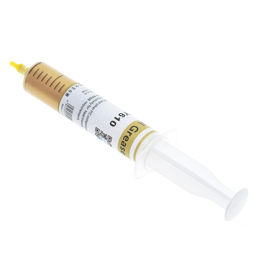 Goldglide – Syringe tilted with yellow tip at upper left, showing the label's QR code and "Grease" text on white