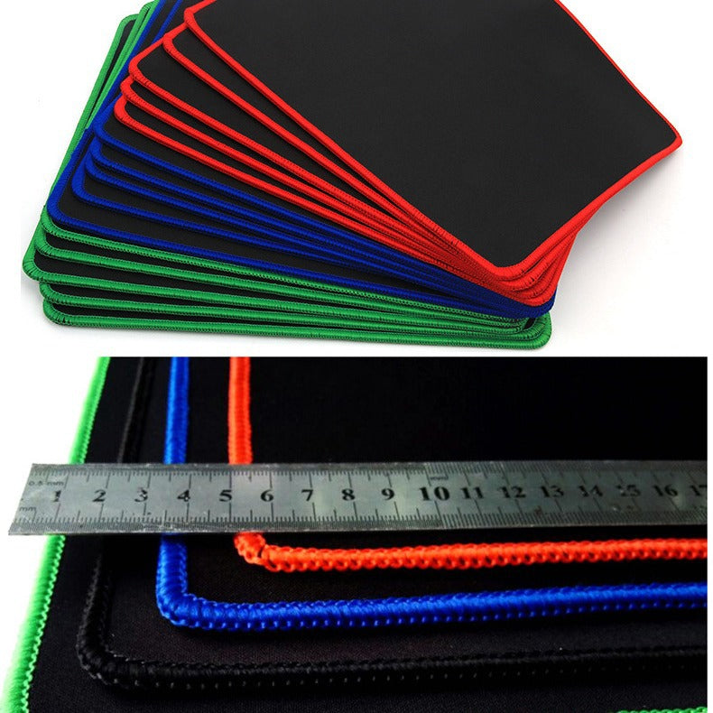Solidgrip Rubber Mouse Pad fanned out in red, blue and green stitched-edge colors above a ruler for scale