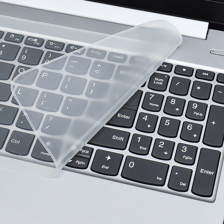 Keyfilm – Clear silicone keyboard cover folded back to show the keys and number pad of a silver laptop