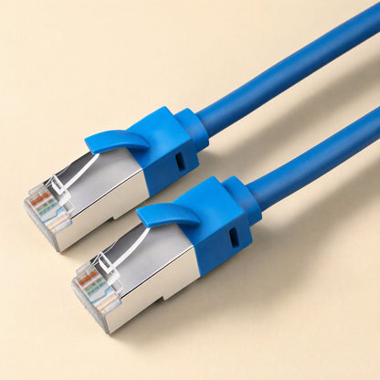 Shieldlink – Pair of dark blue shielded RJ45 connectors with metal housings and blue strain relief boots, close-up