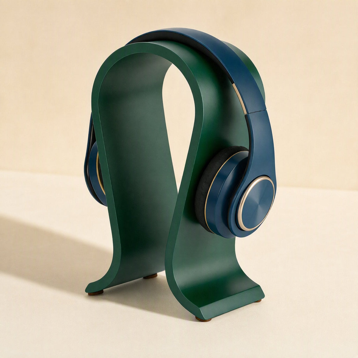 Headperch Aluminum Alloy Headphone Stand in dark green with navy headphones, side angle showing small feet on base