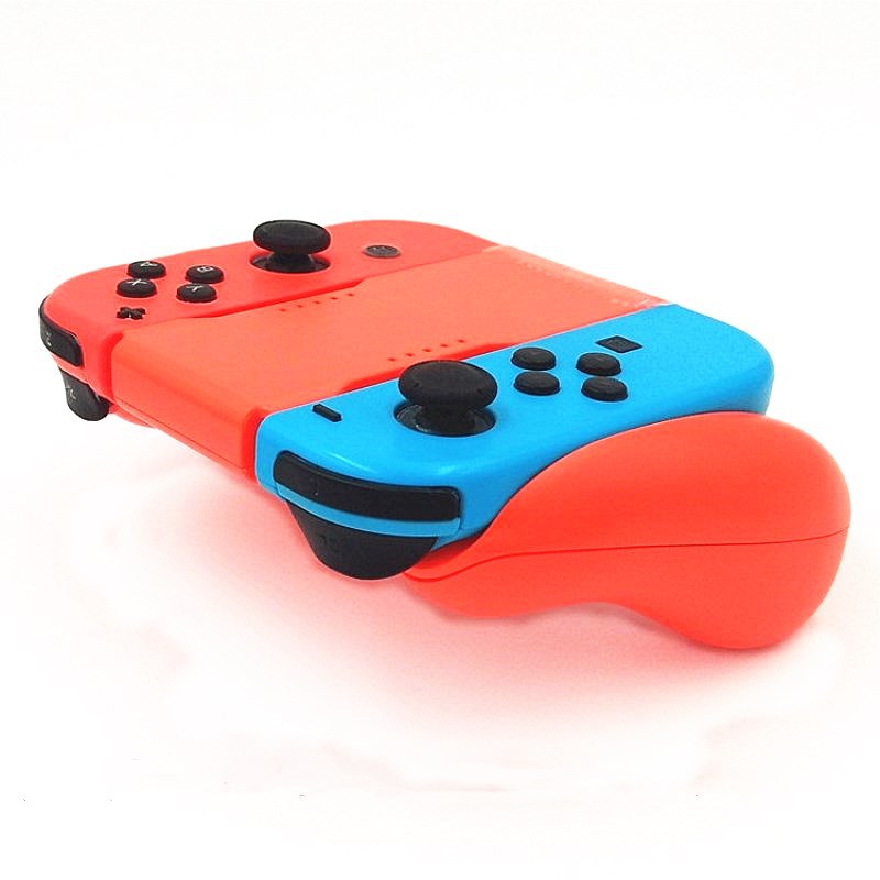 Cradlegrip – Red and blue Joy-Con controllers attached to the orange-red grip, angled view on a white surface