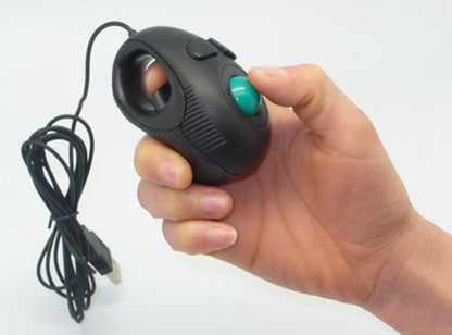 Black handheld trackball mouse in a palm, thumb on the teal ball, with USB cable trailing below
