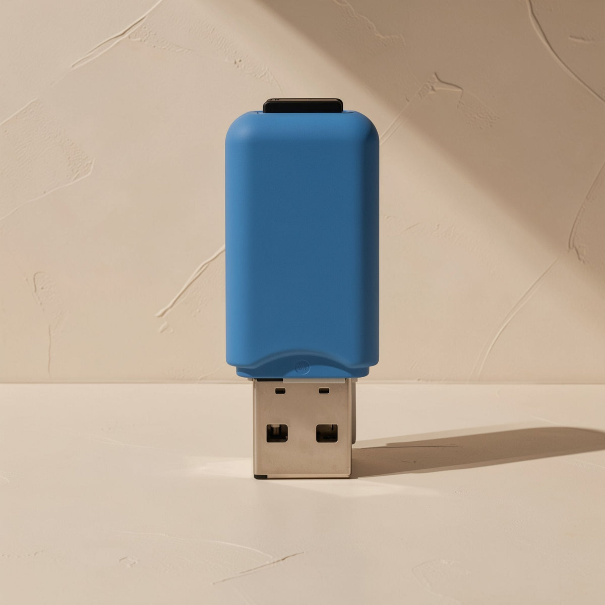 Slotlink – Blue reader standing upright on its USB plug against a textured plaster wall, card slot at the top