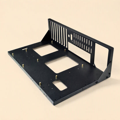 Servernest – Empty black steel open rack frame with brass standoffs, cutouts and a slotted rear panel on a beige background
