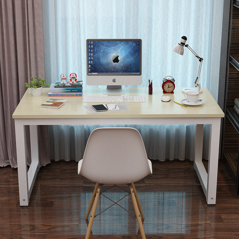 Workstead – Desk with maple-colored top and white legs in front of sheer curtains, with computer and books