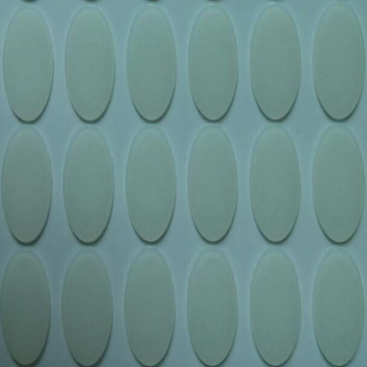 Slidefoot – Close-up of clear oval mouse foot stickers on a backing sheet, arranged in rows of vertical ovals