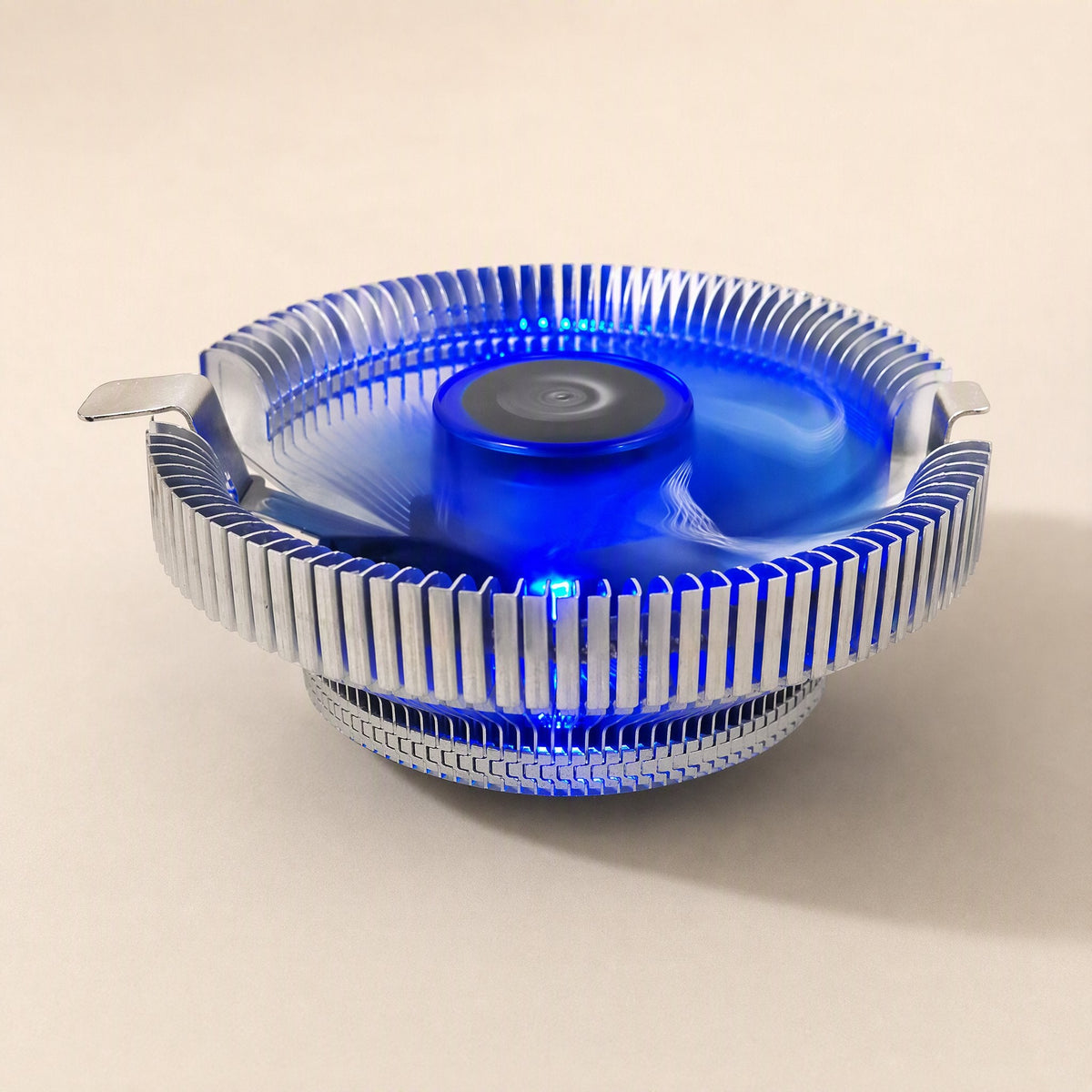 Metalbreeze Aluminum CPU Cooler Fan with glowing blue light, seen from the side on a cream background