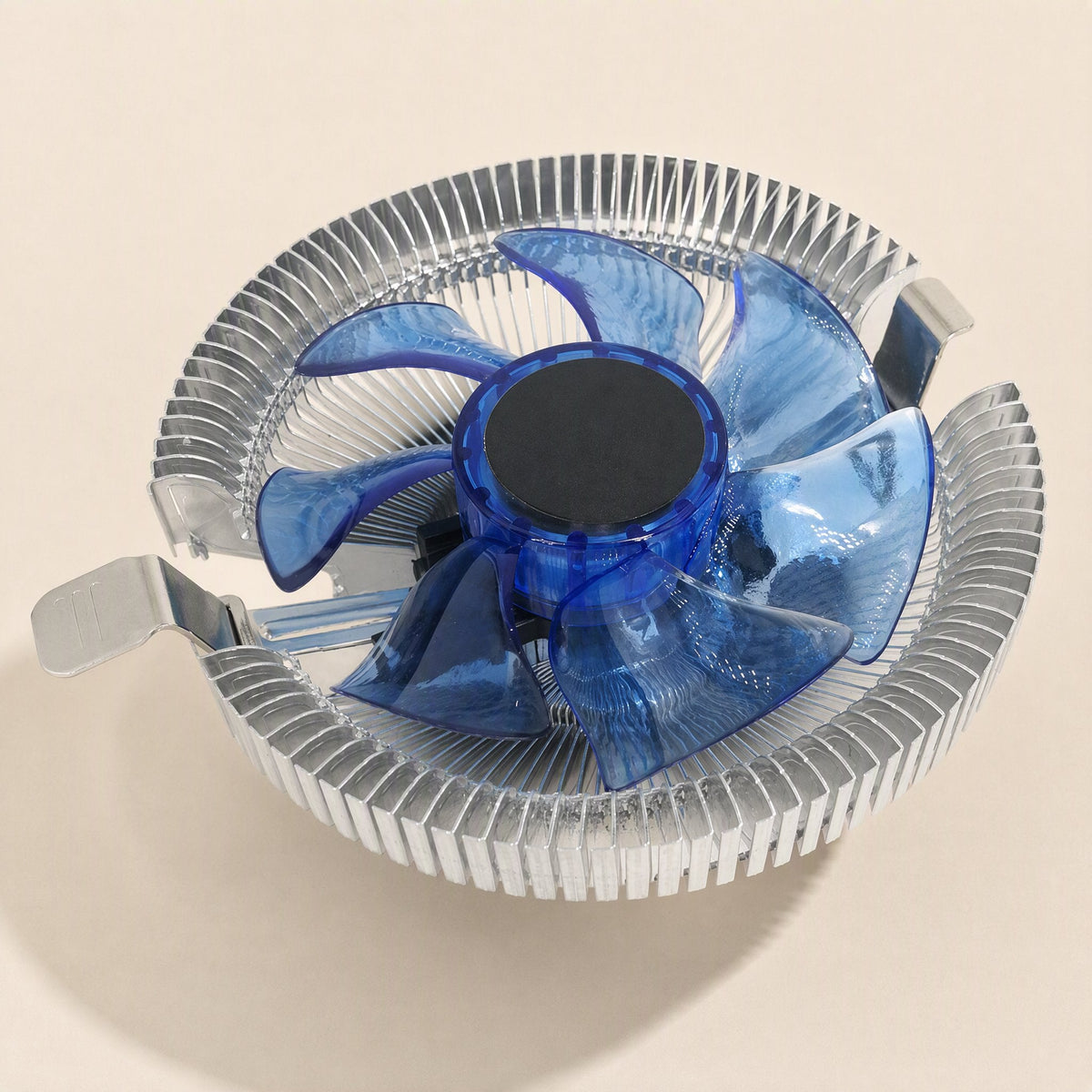 Metalbreeze – Top view of the round silver finned heatsink with translucent blue fan blades and blue center hub