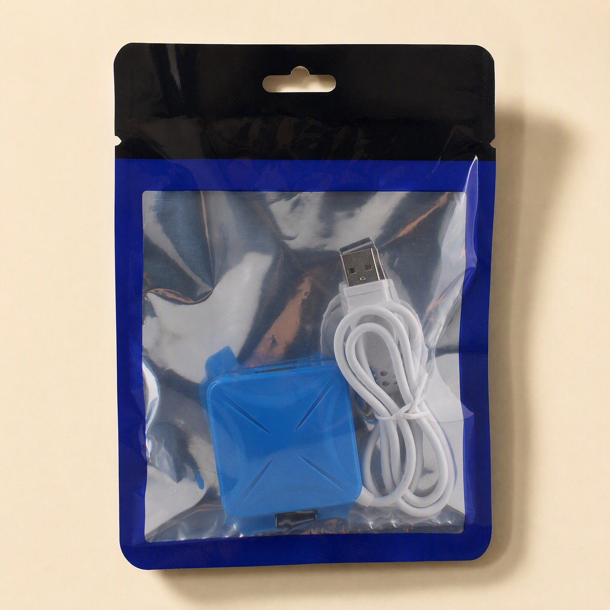 Portcluster – Blue hub with a coiled white cable sealed in a clear zip pouch with black top and blue border
