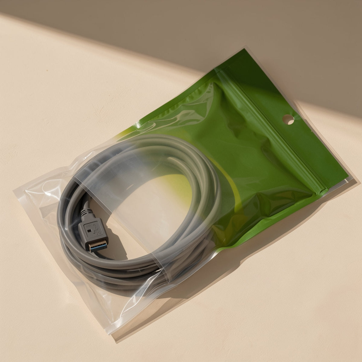 Printcord USB Printer Cable – gray USB cable coiled inside a clear and green resealable bag with a hang hole at the top