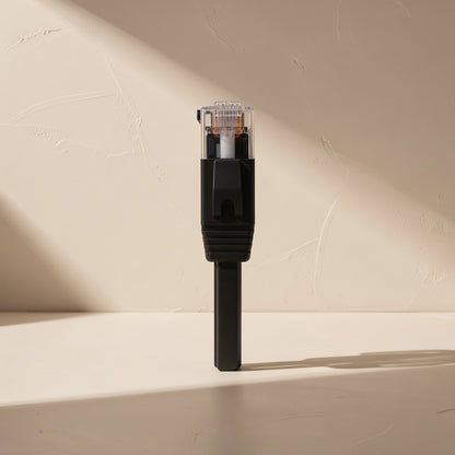 Flatlink – Close-up of a black RJ45 connector with clear plug and strain relief on a flat cable, standing upright