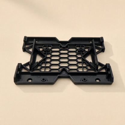 Drivecradle – Black bracket tilted to show its raised side rails and mounting posts on a beige background