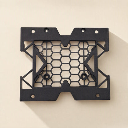 Drivecradle – Black hexagon-mesh bracket viewed flat from above, empty, with four screw holes along the edges