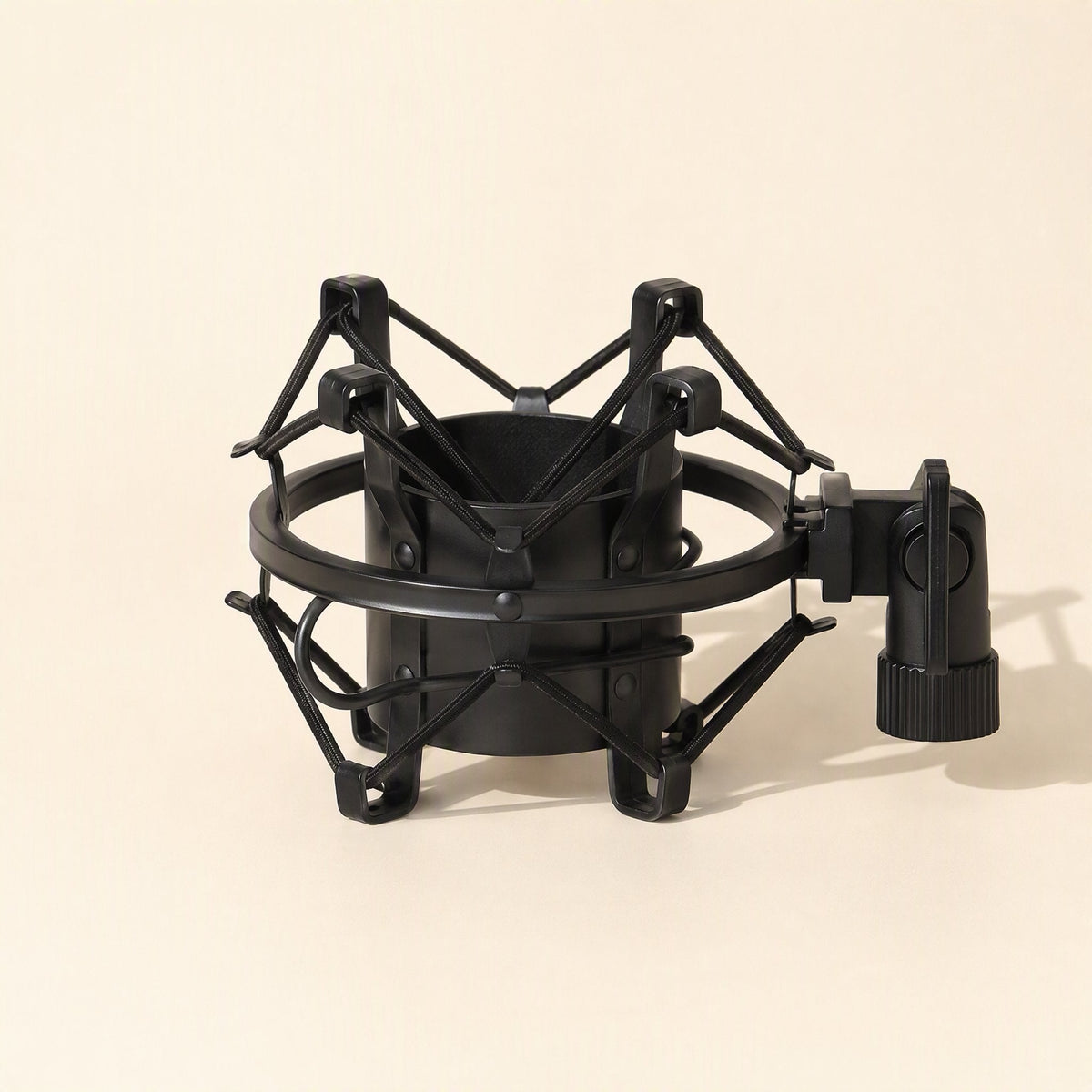 Joltcradle – Black spider-style shock mount with a cylindrical cradle and side clamp, shown from a three-quarter angle