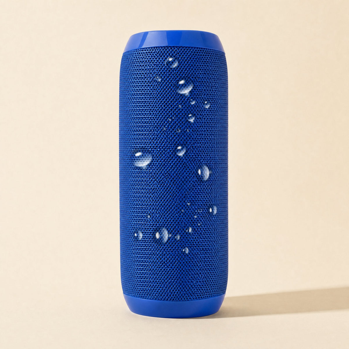 Rainbeat Waterproof Bluetooth Speaker – blue fabric cylinder speaker with water droplets beading on its mesh surface