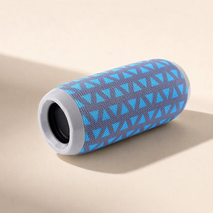 Rainbeat – Grey and blue triangle-patterned speaker lying on its side, showing the round speaker opening