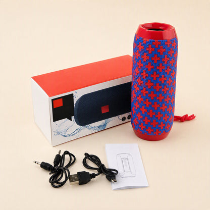 Rainbeat – Red and blue cross-patterned speaker beside its retail box, aux cable, USB charging cable and manual