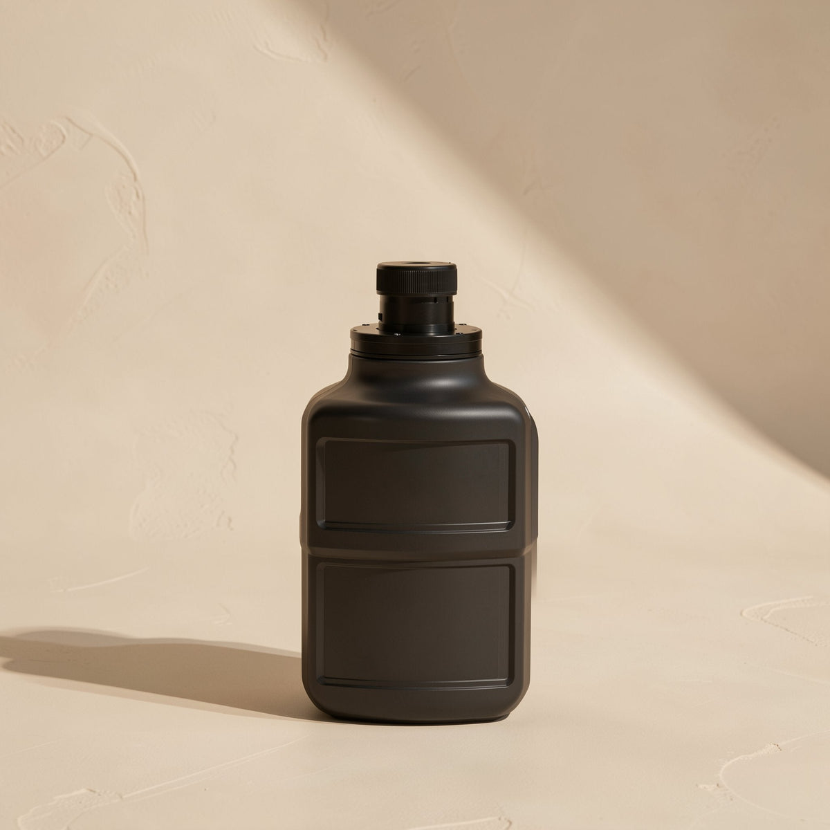 Cablejoin – Matte black bottle with a small black cap, standing on a beige surface with angled shadow
