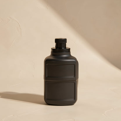 Cablejoin – Matte black bottle with a small black cap, standing on a beige surface with angled shadow