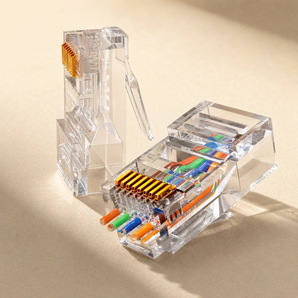 Netclick – Two clear RJ45 connectors with colored wires inserted, showing the 8 gold contacts and wire order