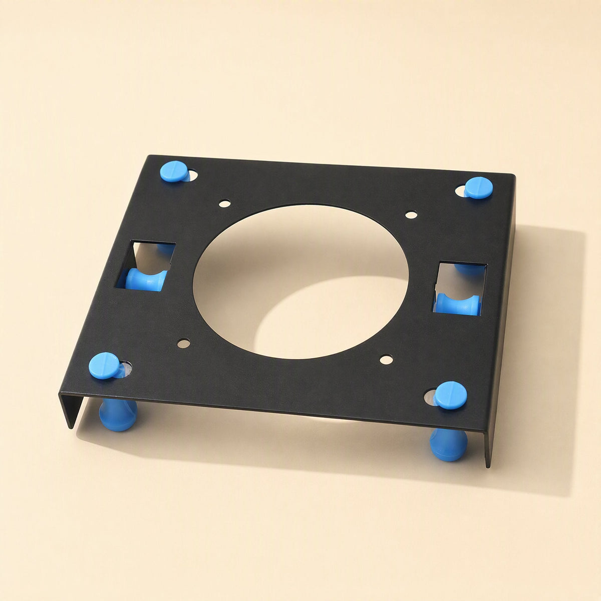 Rackshift – Front-facing view of the black rack with square side slots and four blue pegs on a beige background