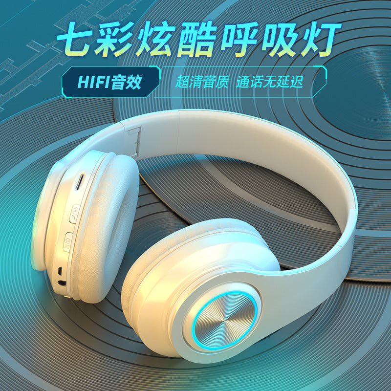 Glowband – White headset on a vinyl record backdrop, side view showing control buttons and charging port by the ear cup