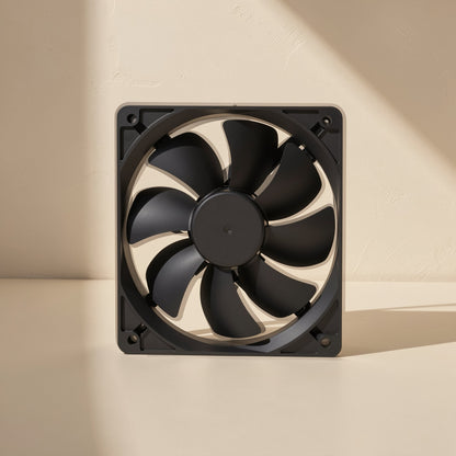 Chillspin – Front view of a black 12 cm chassis fan with seven curved blades, standing in soft side light