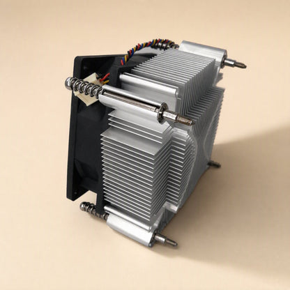 Socketchill – Cooler tilted on its side, showing the fan, coiled mounting springs, long screws and stacked fin edges