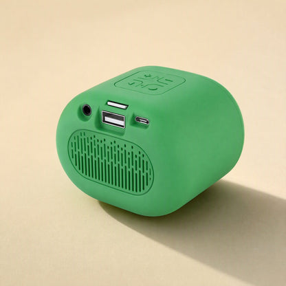 Beatburst – Green speaker rear view showing aux jack, card slot, USB port and charging port above a vented panel
