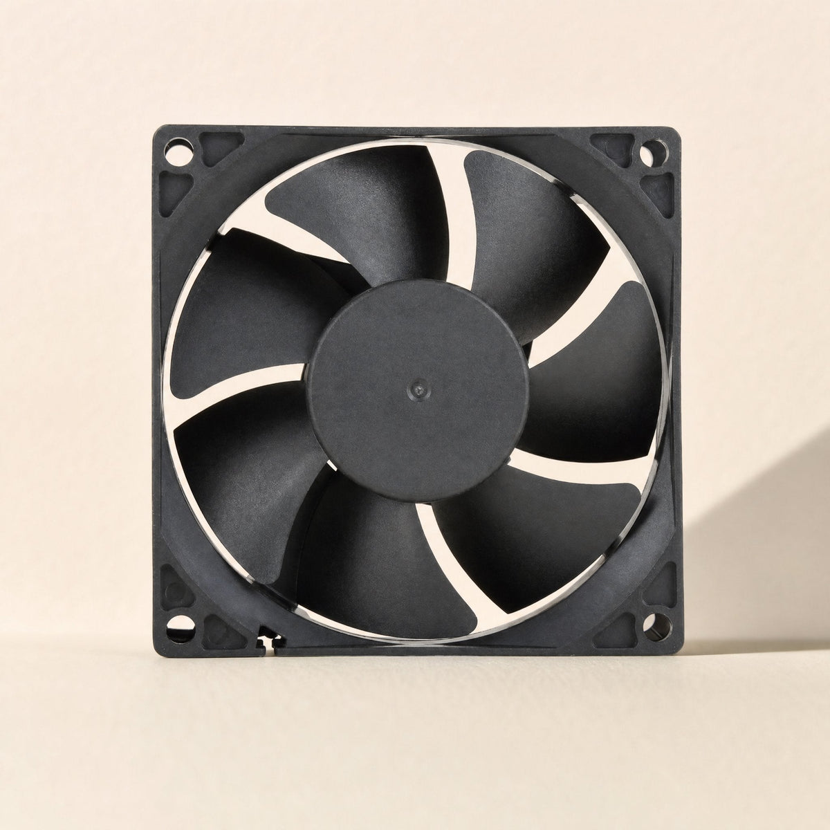 Casecool computer case cooling fan, black square frame with seven-blade rotor, front view on cream backdrop