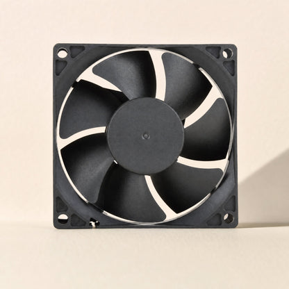 Casecool computer case cooling fan, black square frame with seven-blade rotor, front view on cream backdrop