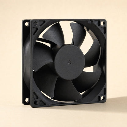 Casecool – Black square cooling fan angled to show frame depth, hub and curved blades against a warm beige background