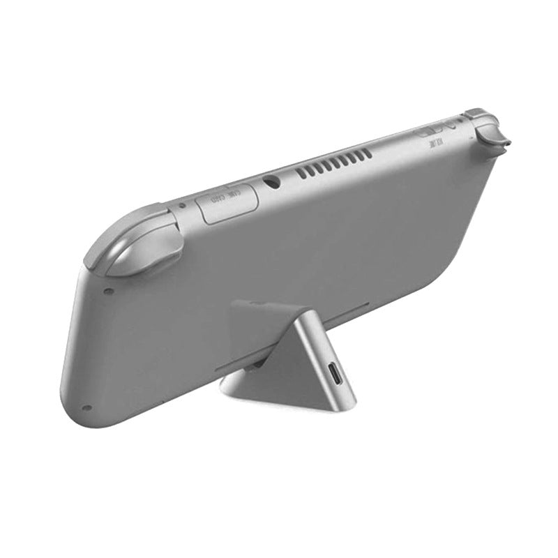 Dockcharge – Rear view of a gray Switch Lite resting on the triangular base, USB Type-C port visible