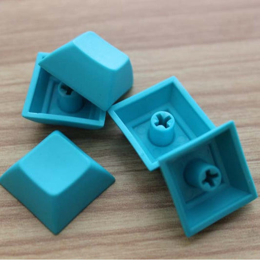 Keystature DSA PBT Mechanical Keycap – four teal DSA keycaps, two upright and two upside down showing the MX cross stems