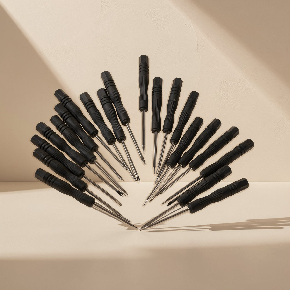 Screwbit Blackhead Mobile Phone Screwdriver set fanned out in a half-circle on a cream background