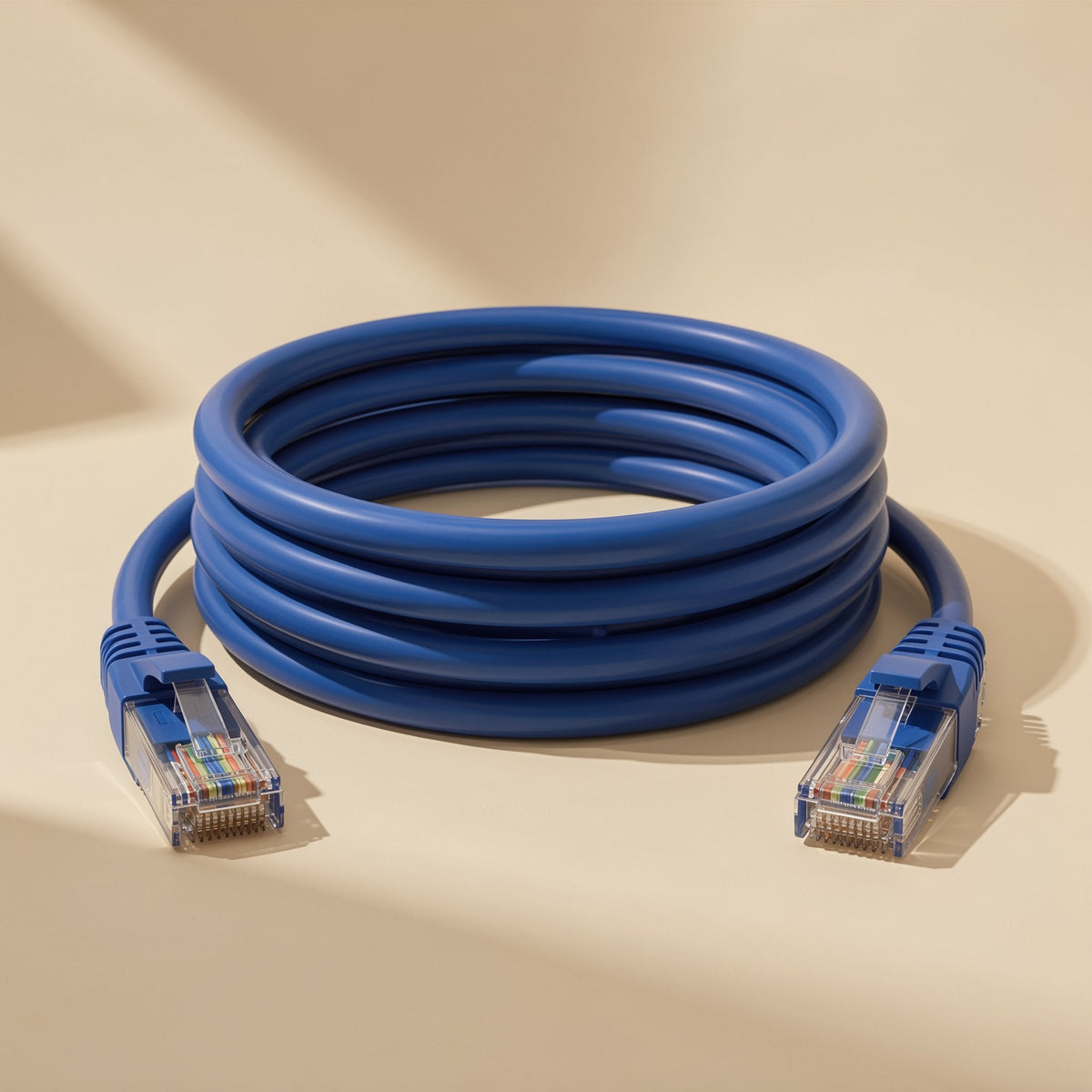 Gigabraid – Close-up of coiled blue Cat6 Ethernet cable with clear RJ-45 connectors showing color-coded wires